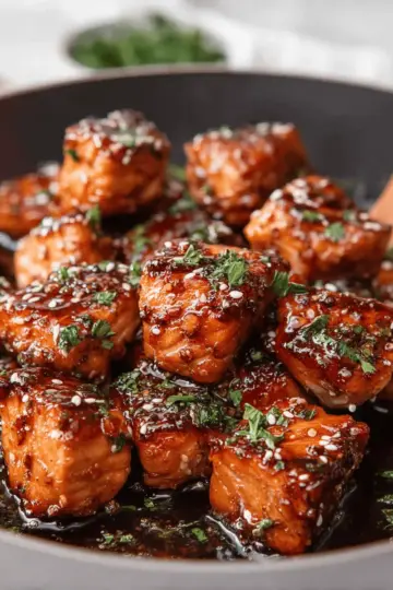 Crispy, Saucy Honey Garlic Salmon Bites in a Skillet